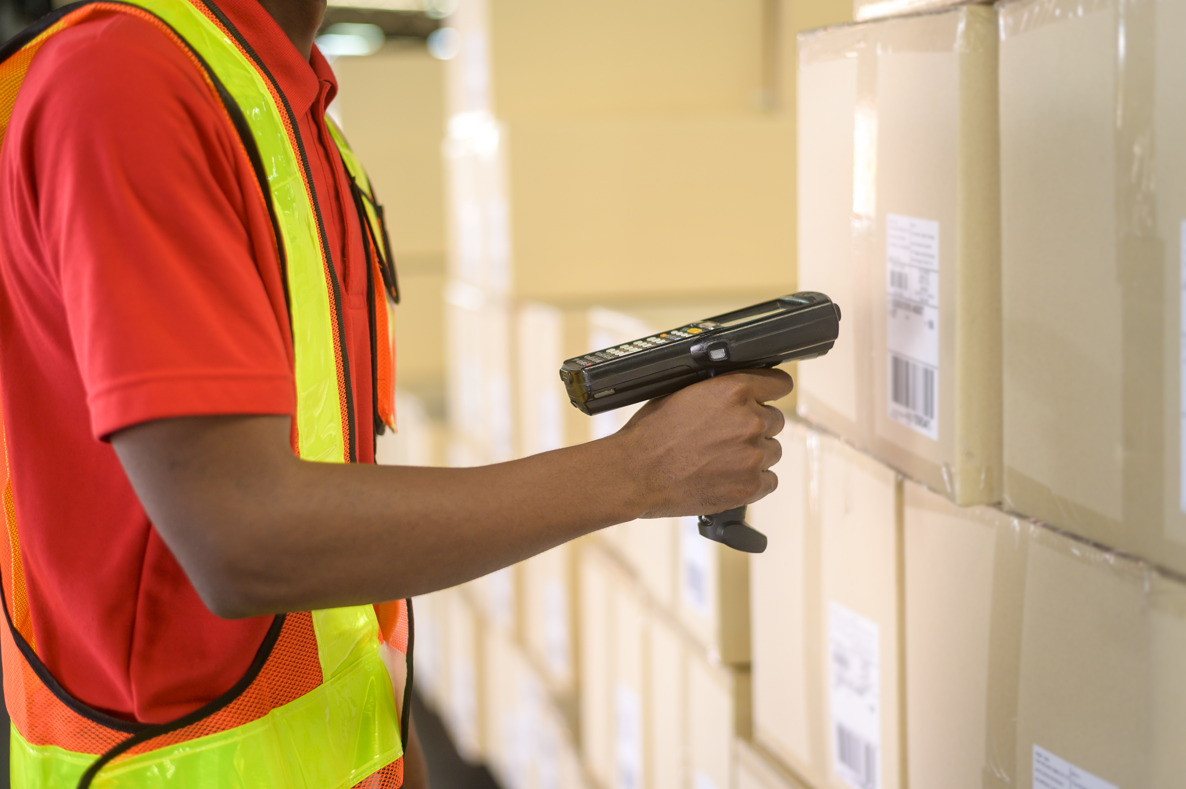 young-worker-wearing-helmet-scanning-parcels-retail-transport-shipping-modern-warehouse.jpg